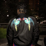 Pusha T Wears A Gucci Nylon Bomber Jacket With Embroidery & Bottega Veneta Hiking Suede And Mesh High-Top Trainers