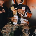 A-Boogie Wit Da Hoodie Bundled-Up In A Gucci Hooded Nylon Caban Down Jacket Styled With Amiri Camo Skinny Trousers
