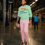 NBA Style: Carmelo Anthony Wears A Valentino Jamie Reid Slogan Intarsia Jumper And Heros Tribe 1 Mesh & Suede Sneakers