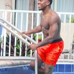 Rising Model Raheem Pierre Spotted Swimming In Nautica Shorts