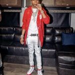 Rapper Lil Baby Spotted In A Moncler 8 x Palm Angels Red Patent Leather Jacket & Air Jordan 9 Retro ‘Gym Red’