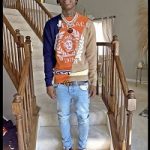 Rapper Polo G Sports A Versace Intarsia-Knit Jumper & Chain Reaction Low-Top Sneakers