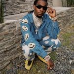Offset Does An Impromptu Photoshoot In A Kapital Embroidered Denim Jacket, Burberry Bleached Splatter Effect Jeans And Air Jordan 14 “Yellow Ferrari” Sneakers