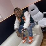 Rapper Lil Durk Wears An Off-White Green And Orange Varsity Bomber Jacket & Nike Dunk Low SP Syracuse Sneakers