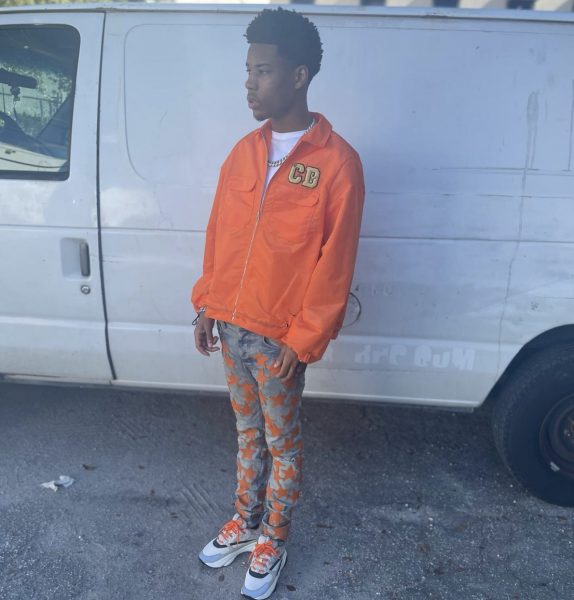 Rapper Nardo Wick Dressed In A Dior x Kenny Scharf Orange Shirt