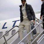 Basketball Player Bones Hyland Spotted Getting Off A Plane In An Essentials Beige Knit ‘1977’ Hoodie, Lounge Pants And Dior B 22 Sneakers