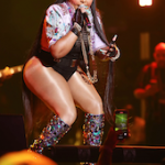 Iconic Rapper Lil Kim Performs At Essence Fest In A Sheer Black Bodysuit, Dolce & Gabbana Crystal Embellished Pointed Toe Boots And Multicolor Jewel Jacquard Box Shoulder Bag