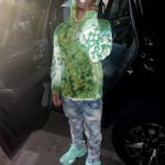 Mikey Williams Poses In An Amiri Tie Dye Logo Cotton Hoodie, Purple Brand Bleached Distressed Slim Leg Jeans And Balenciaga Green Track Sneakers