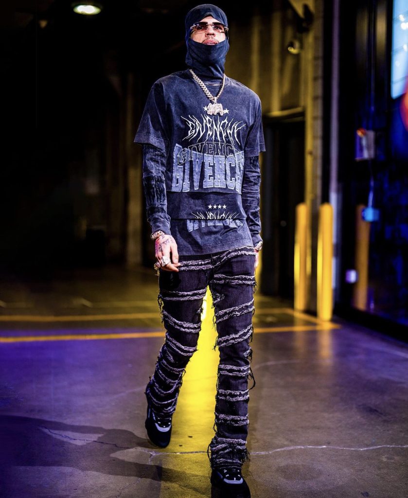 NBA Player LaMelo Ball Stepped Out In A Givenchy Layered Graphic T-Shirt w/ Balaclava, Valabasas Stacked Flared Jeans And Men's B22 Sneakers - Donovan Moore Fashion Book