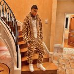NLE Choppa Poses In A Burberry TB Monogram Jacquard Sweatsuit And Nike Air Force 1 Sneakers