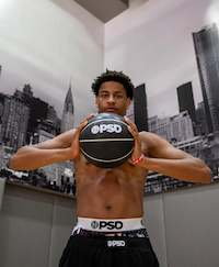 A young man holding a basketball in his hands and wearing PSD Underwear NIL Deal.