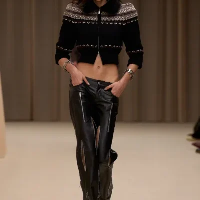 Runway model wearing cropped sweater and leather pants