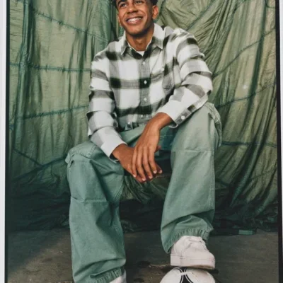 Smiling young man with foot on soccer ball