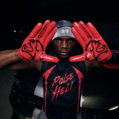 Athlete framing face with red gloves