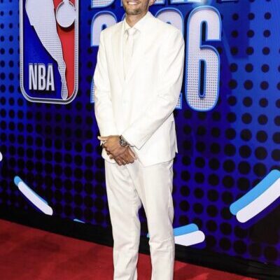 Smiling man in white suit at NBA Draft
